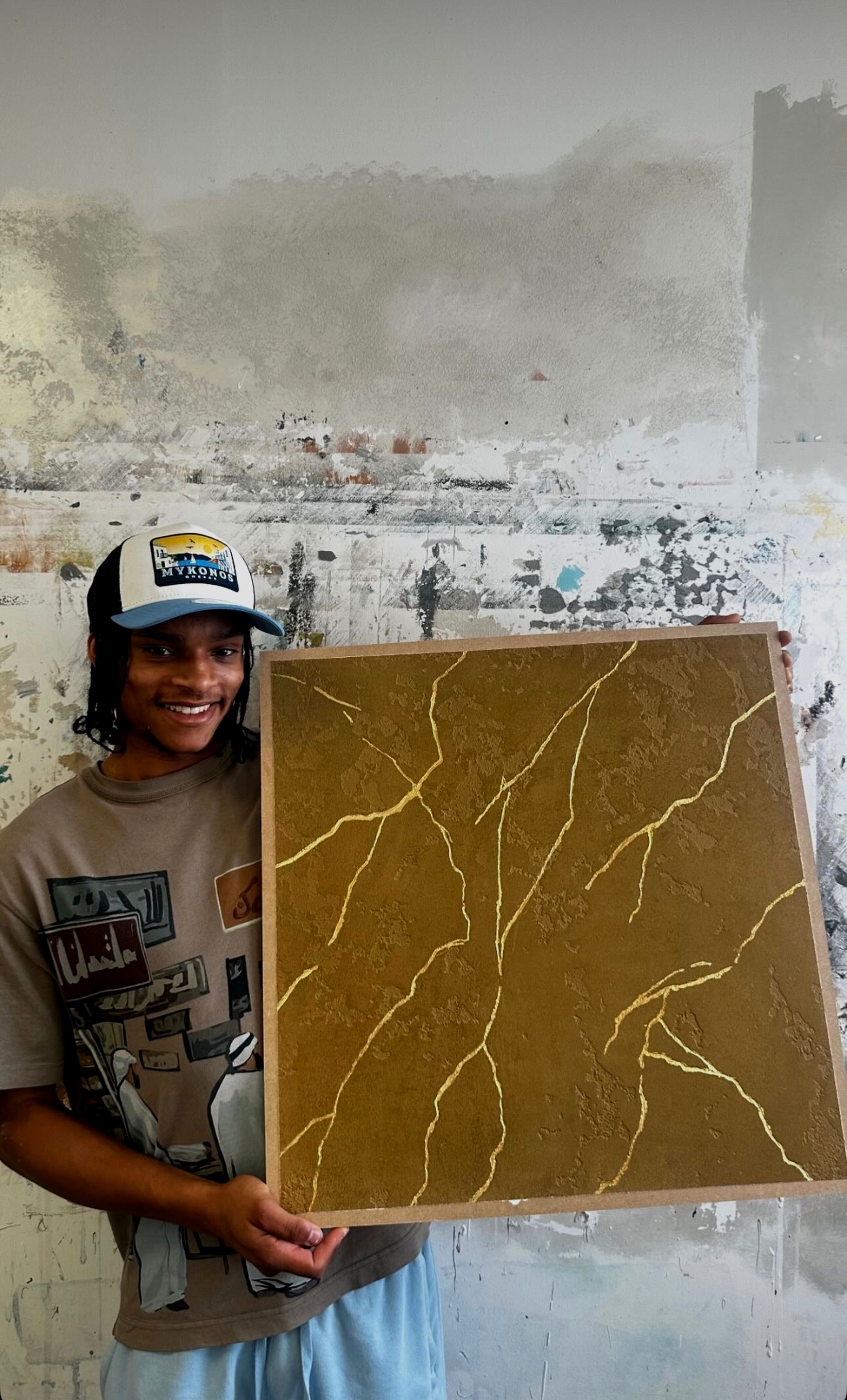 KyroAtelier craftsman holding a bespoke Kintsugi Onyx gold-veined plaster sample board